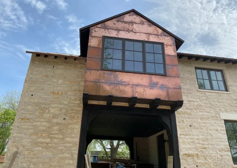 Copper metal panel facade on a stone building for Metal Roof Coating in Alderwood Manor
